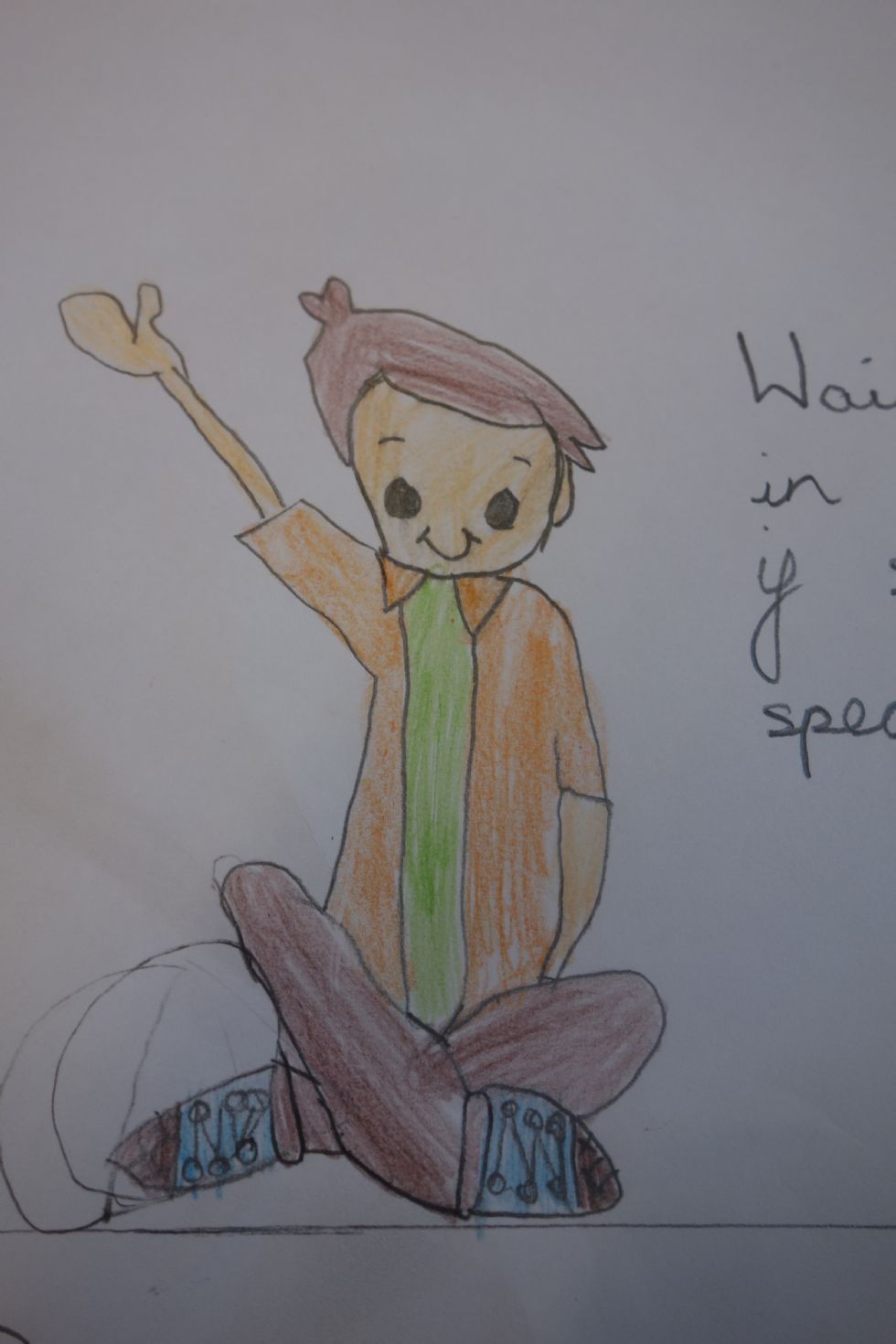  A child's drawing of a boy sitting with crossed legs putting his hand up