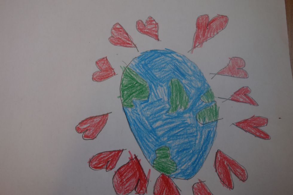  A child's drawing of a globe with love hearts around it